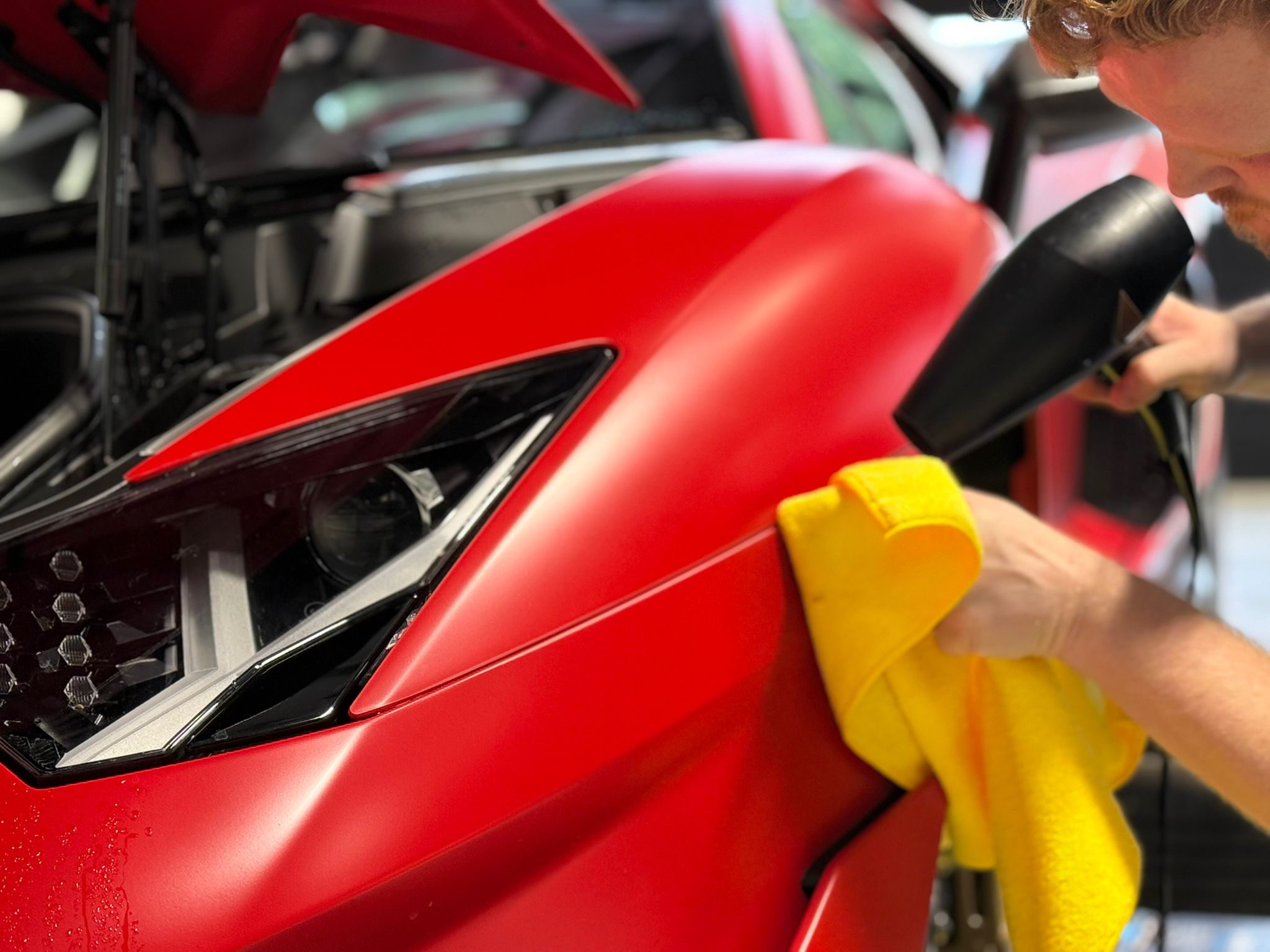 Detailing red Lamborghini headlight at Prestige Protect